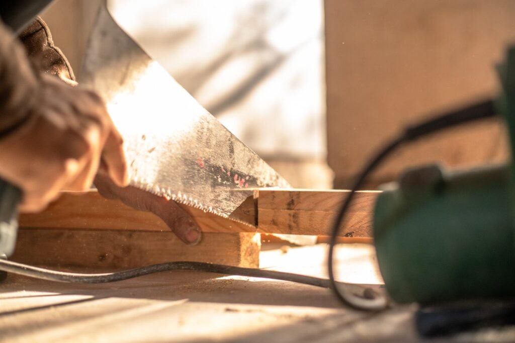 A hand saw cutting timber